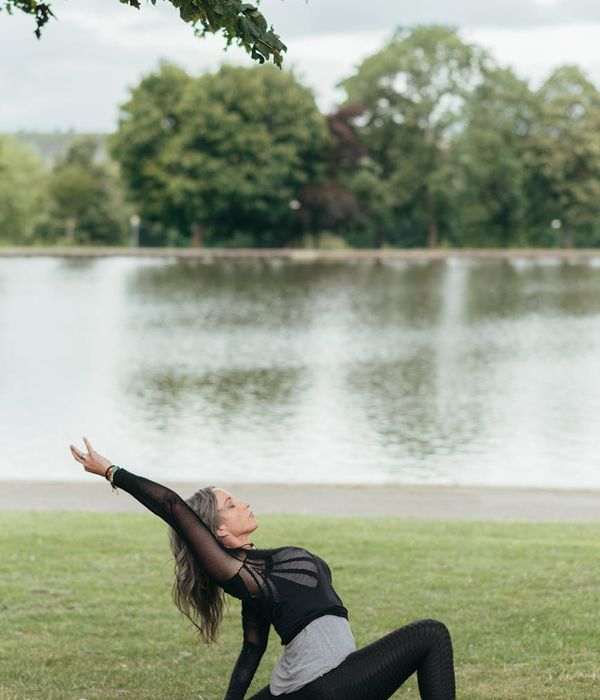 Woman performing a graceful yoga stretch in a calm environment.